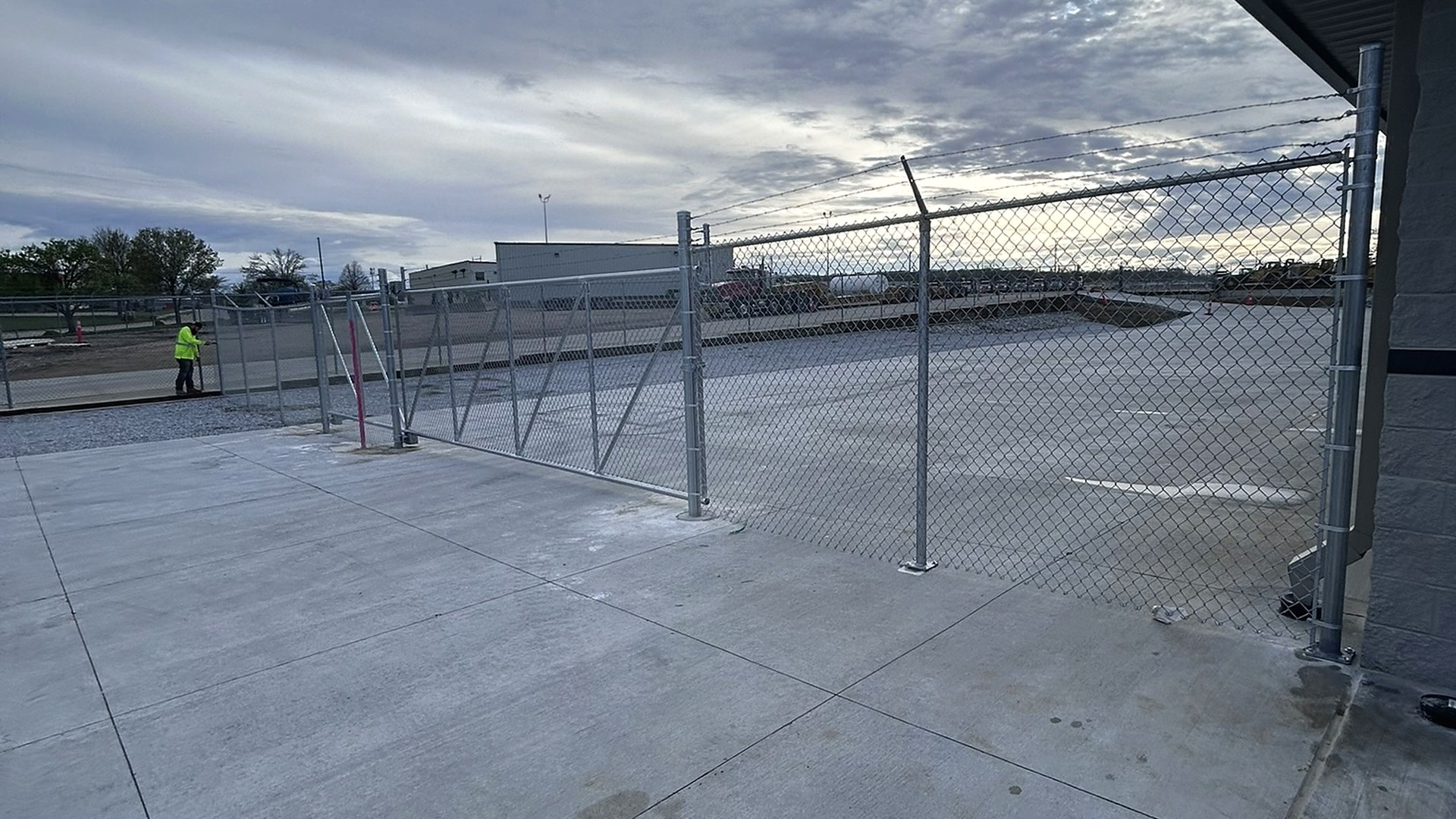ECS Fence crew on the job under a dramatic sky
