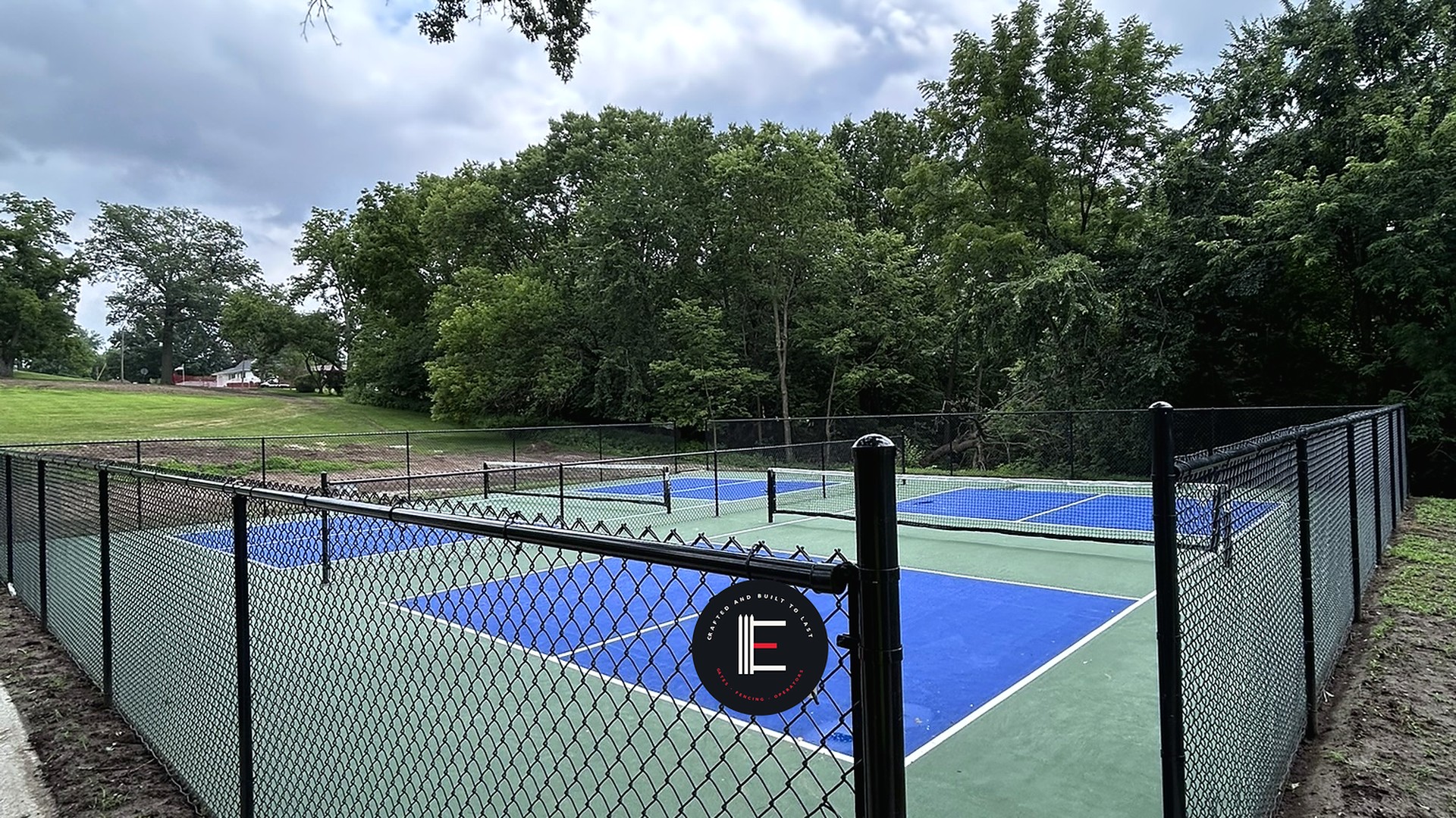 Commercial chain link enclosure on a sports court — ECS install