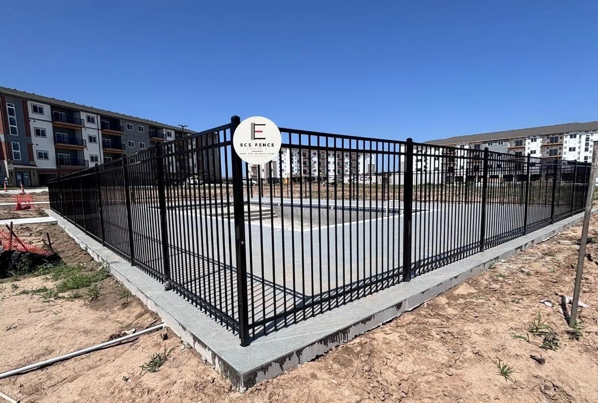 Black aluminum pool-code fence around a new pool — ECS Fence install